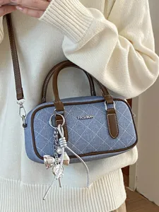 Blue denim quilted shoulder bag with brown leather trim, stylish pillow bag for women daily commute.