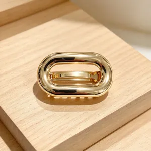 Dettaglio fermaglio per capelli ovale in metallo dorato, accessorio retro elegante.