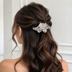 Silver metal hair claw clip with abstract fluid design for elegant updo hairstyles.