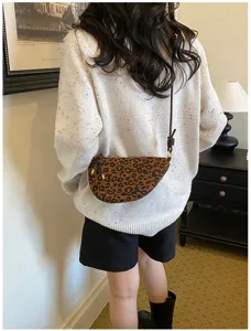 Detail shot of the vintage leopard print suede half-moon shoulder bag with a chic crossbody strap.