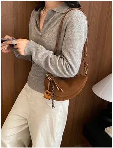 Retro suede half-moon shoulder bag for women, chic crossbody purse with stylish knotted strap.