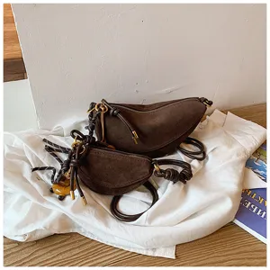 Brown suede half-moon shoulder bag, chic vintage underarm bag with stylish knot details.