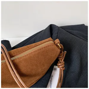 Vintage suede underarm bag half-moon crossbody shoulder bag detail view fashion chic purse.