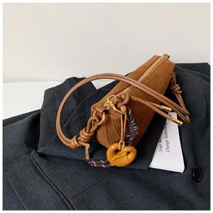 Brown suede cylindrical shoulder bag detail, vintage half moon crossbody bag with metal hardware.