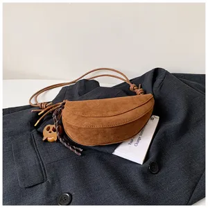 Brown suede half-moon bag detail shot, vintage style crossbody shoulder bag showcasing texture.