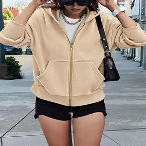 Close-up detail view of the casual beige zip-up hoodie featuring long sleeves and front pockets.