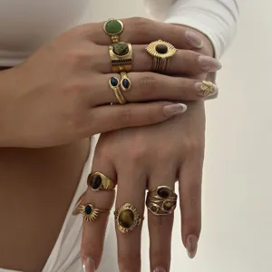Detailed view of gold plated irregular lava gemstone stacked rings, vintage retro style jewelry.