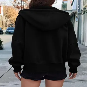 Back detail view of black zip-up hoodie, casual street style apparel for autumn season.