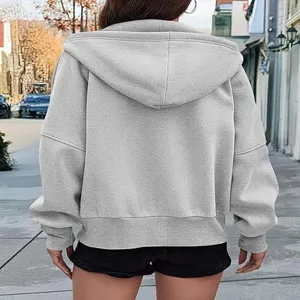 Back view detail of grey zip-up hoodie sweatshirt, soft fleece fabric and casual crop style.
