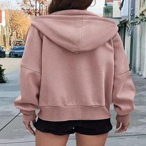 Details of women's pink zip-up hooded sweatshirt, featuring long sleeves and casual style.