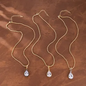 Collares de cadena de cuentas doradas con elegantes colgantes de circonita en pera, detalle.