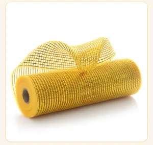 Close-up shot of yellow metallic mesh ribbon roll for Christmas decoration, shiny texture.