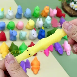 Close-up detail view of colorful dinosaur mochi squishy toys showing soft texture and elastic stretch.