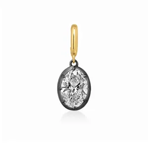 Colgante de circonita ovalada con anilla dorada y montura negra para joyería DIY.