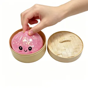 Close-up detail of a cute glitter pink bun squishy toy displayed with a mini steamer.