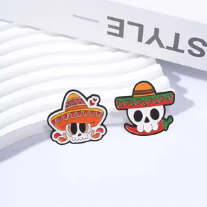 Closeup detail view of colorful Mexican Day of the Dead skull and chili metal enamel pins.