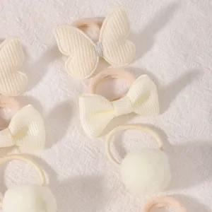 Cute baby hair ties set featuring bow and pom-pom designs in cream white, gentle for kids.