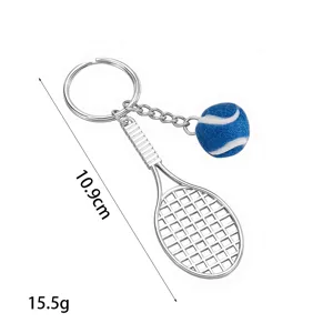 Detailed close-up view of the metal tennis racket keychain with a blue tennis ball pendant.
