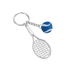 Close up detail view of metal tennis racket keychain featuring a textured blue tennis ball.