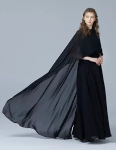 Detail view of a flowing black chiffon women cape shawl, elegant sheer fabric design.