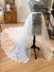 Bridal tulle skirt with stunning lace long train and sequin mini dress for wedding party.
