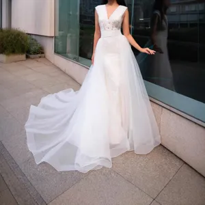 Stunning white bridal organza skirt with intricate lace V-neck bodice and flowing tulle train.