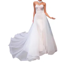 Elegant white strapless wedding dress with tulle detachable overskirt and lace bodice.