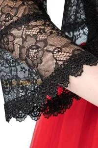 Close-up of black lace cardigan sleeve, intricate floral pattern and delicate scalloped trim.