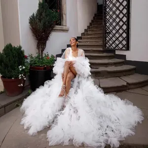 White tulle robe detail shot showcasing the long fluffy train and elegant mesh design.