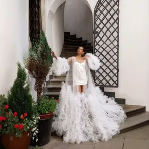 Stunning white tulle maternity photography gown with dramatic long train and fluffy sleeves.