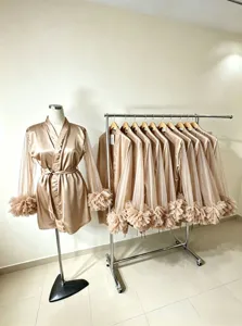 Detailed view of satin and sheer mesh bridal robe with ruffled cuffs and tie belt.