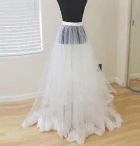 Detachable white tulle bridal overskirt with exquisite lace trim for wedding dress details.