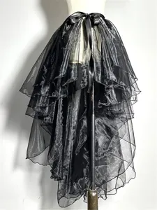 Close-up detail of black layered sheer tulle asymmetrical skirt with satin ribbon tie.