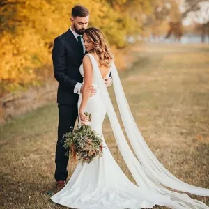 Elegant bridal wedding dress long sheer cape photography detail accessory graceful design.