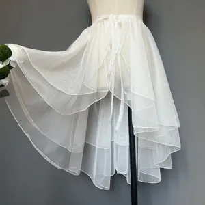 Detailed view of the white high-low layered mesh skirt showing exquisite tulle texture.