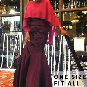 Elegant women's evening dress featuring a magenta chiffon cape and purple satin skirt.
