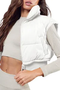 White cropped puffer vest with stand collar and zipper, stylish winter outerwear for women.