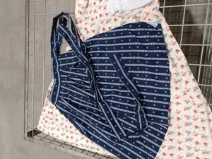 Detailed view of the retro dark blue geometric print apron dress with straps for cosplay.