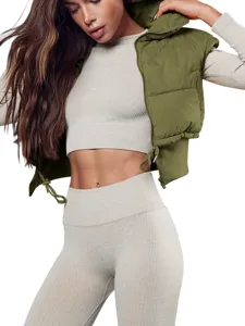 Detail view of women's cropped puffer vest with stand collar, paired with ribbed crop top.