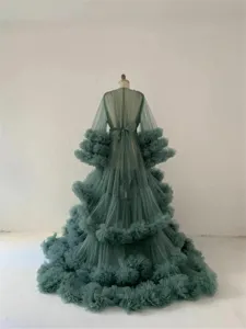 Detailed view of the sheer tulle maternity photography dress with layered ruffles and long sleeves.