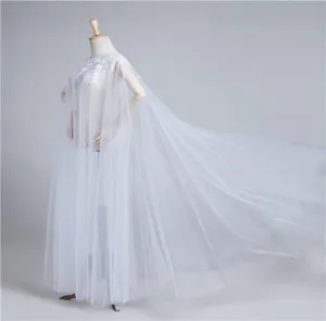 Detailed view of white tulle lace applique long cape cloak, featuring elegant flowing train.