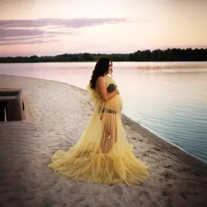 Stunning yellow tulle maternity photography dress with long train and ruffles for photoshoots.
