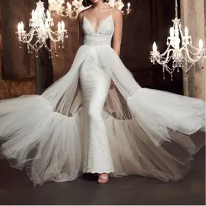 Women's elegant wedding dress with detachable tulle overskirt, stunning bridal gown train.