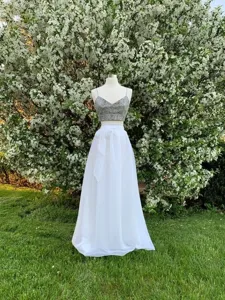 Detailansicht im Freien der weißen Organza Schleifenrock und glitzernden Oberteil.