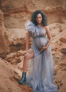 Detailed view of the elegant grey one-shoulder tulle maternity dress, perfect for outdoor photos.