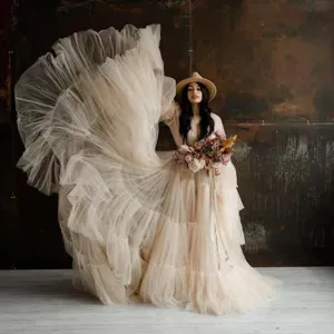 Stunning tulle photography dress detail, voluminous mesh gown in beige, scenic backdrop.