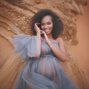 Elegant grey off-the-shoulder tulle maternity dress, perfect for outdoor photography sessions.