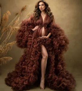 Luxurious brown tulle maternity dress with dramatic ruffles and bow, perfect for studio photo shoots.