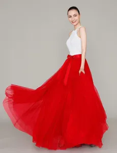 Detailed view of the red tulle maxi skirt featuring voluminous mesh layers and a bow waist tie.