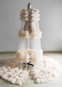 Detailed view of layered mesh long train dress, featuring ruffled tulle design for photos.